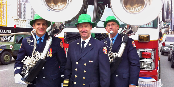 Fire Chief John McKearney, with Dan and Wayne sporting the band's new tubas, standing in front of Ladder 7, preparing for the 2012 St. Patrick's Day Parade, Vancouver.